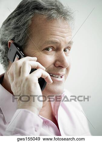 Portrait of a mature man talking on a mobile phone View Large Photo Image Stock Photo - Portrait of a mature man talking on a mobile phone. Fotosearch