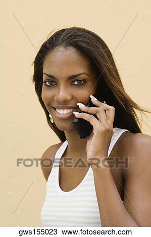 Portrait of a teenage girl using a mobile phone and smiling View Large Photo Image Stock Image - Portrait of a teenage girl using a mobile phone and smiling. Fotosearch