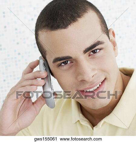 Portrait of a young man using a mobile phone View Large Photo Image Stock Image - Portrait of a young man using a mobile phone. Fotosearch