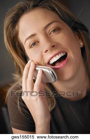 Stock Photography - Portrait of a young woman talking on a mobile phone. Fotosearch