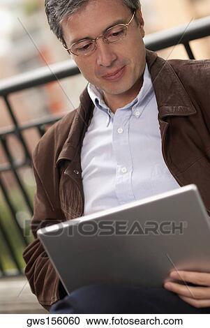 Close-up of a businessman using a laptop View Large Photo Image Stock Image - Close-up of a businessman using a laptop. Fotosearch