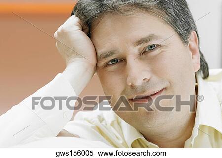 Portrait of a mature man thinking with his hand on his temple View Large Photo Image Stock Photography - Portrait of a mature man thinking with his hand on his temple. Fotosearch