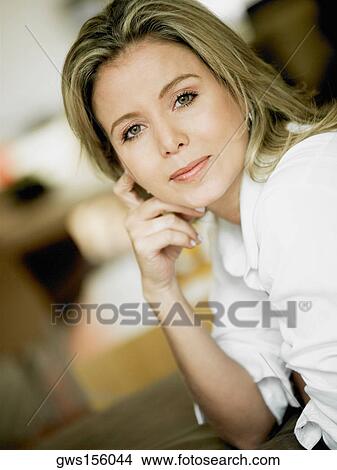 Portrait of a mid adult woman thinking View Large Photo Image Picture - Portrait of a mid adult woman thinking. Fotosearch