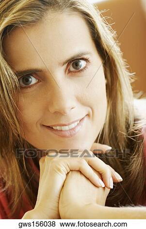 Portrait of a mid adult woman with her hand on her chin View Large Photo Image Stock Photo - Portrait of a mid adult woman with her hand on her chin. Fotosearch