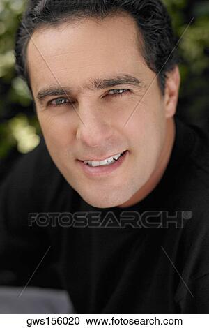 Portrait of a young man smirking View Large Photo Image Stock Image - Portrait of a young man smirking. Fotosearch