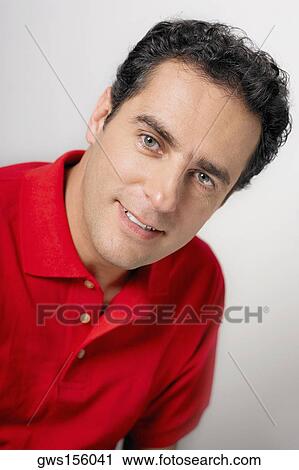 Stock Image - Portrait of a young man smirking. Fotosearch