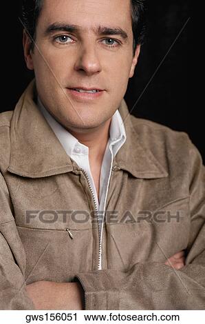 Portrait of a young man with his arms crossed View Large Photo Image Stock Image - Portrait of a young man with his arms crossed. Fotosearch