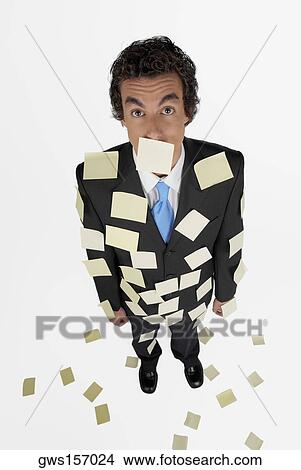 High angle view of a businessman standing with adhesive notes on his body View Large Photo Image Picture - High angle view of a businessman standing with adhesive notes on his body. Fotosearch