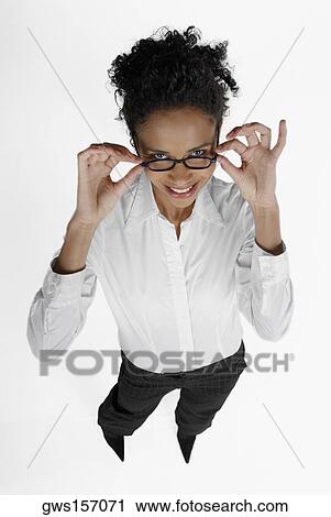 High angle view of a businesswoman adjusting her eyeglasses View Large Photo Image Stock Image - High angle view of a businesswoman adjusting her eyeglasses. Fotosearch