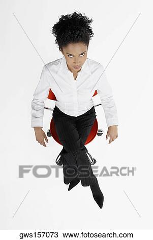High angle view of a businesswoman sitting on an office chair View Large Photo Image Stock Image - High angle view of a businesswoman sitting on an office chair. Fotosearch