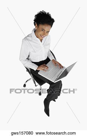 High angle view of a businesswoman using a laptop View Large Photo Image Stock Image - High angle view of a businesswoman using a laptop. Fotosearch