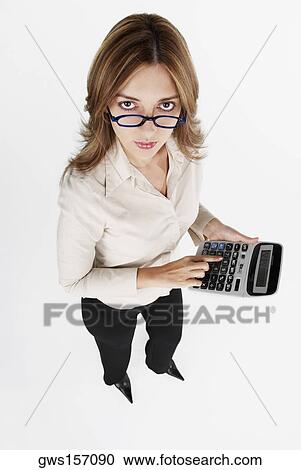 High angle view of a businesswoman using a calculator View Large Photo Image Stock Image - High angle view of a businesswoman using a calculator. Fotosearch