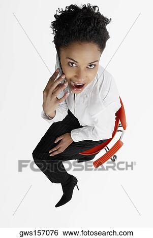 Stock Photograph - High angle view of a businesswoman talking on a mobile phone. Fotosearch