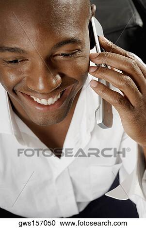 High angle view of a young man using a mobile phone View Large Photo Image Stock Image - High angle view of a young man using a mobile phone. Fotosearch