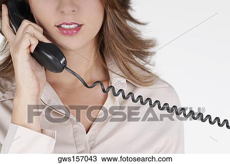Mid section view of a businesswoman talking on the telephone View Large Photo Image Stock Image - Mid section view of a businesswoman talking on the telephone. Fotosearch