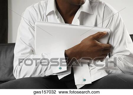 Mid section view of a person hugging a laptop View Large Photo Image Stock Image - Mid section view of a person hugging a laptop. Fotosearch