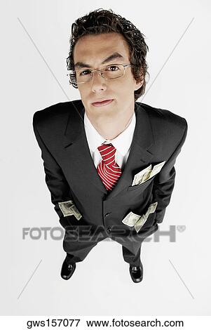 Portrait of a businessman with paper currency in his pockets View Large Photo Image Stock Photo - Portrait of a businessman with paper currency in his pockets. Fotosearch