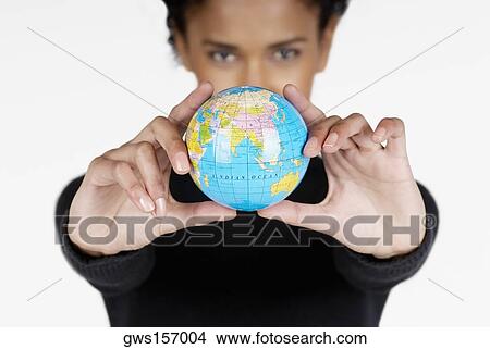 Portrait of a businesswoman holding a globe View Large Photo Image Picture - Portrait of a businesswoman holding a globe. Fotosearch