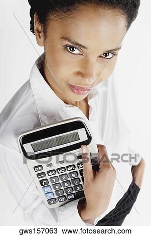 Portrait of a businesswoman holding a calculator View Large Photo Image Stock Image - Portrait of a businesswoman holding a calculator. Fotosearch