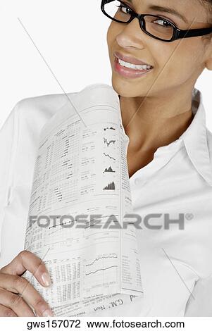 Portrait of a businesswoman holding a financial newspaper and smiling View Large Photo Image Stock Image - Portrait of a businesswoman holding a financial newspaper and smiling. Fotosearch