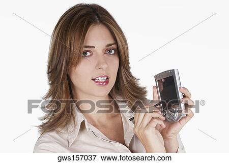 Stock Photo - Portrait of a businesswoman operating a hand held device with a digitized pen. Fotosearch
