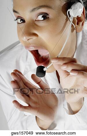 Portrait of a female customer service representative talking on a headset View Large Photo Image Stock Photo - Portrait of a female customer service representative talking on a headset. Fotosearch