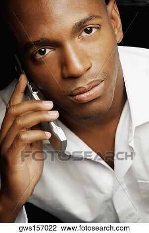 Portrait of a young man talking on a mobile phone View Large Photo Image Stock Image - Portrait of a young man talking on a mobile phone. Fotosearch
