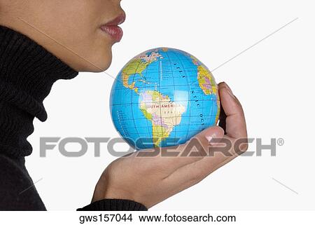 Side profile of a businesswoman holding a globe View Large Photo Image Picture - Side profile of a businesswoman holding a globe. Fotosearch