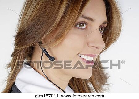 Side profile of a businesswoman with a hands free device View Large Photo Image Stock Image - Side profile of a businesswoman with a hands free device. Fotosearch