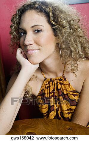 Portrait of a teenage girl smiling with her hand on her chin View Large Photo Image Stock Image - Portrait of a teenage girl smiling with her hand on her chin. Fotosearch