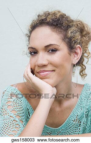 Portrait of a teenage girl with her hand on her chin View Large Photo Image Stock Image - Portrait of a teenage girl with her hand on her chin. Fotosearch