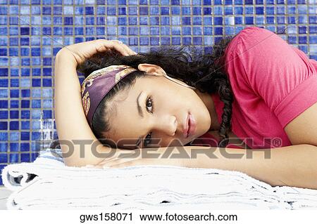 Portrait of a young woman lying down View Large Photo Image Stock Image - Portrait of a young woman lying down. Fotosearch