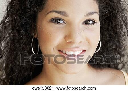 Portrait of a young woman smiling View Large Photo Image Stock Image - Portrait of a young woman smiling. Fotosearch