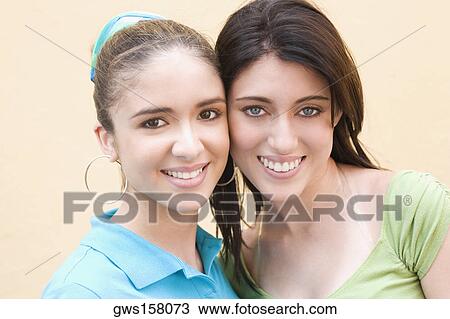 Stock Image - Portrait of two teenage girls smiling. Fotosearch