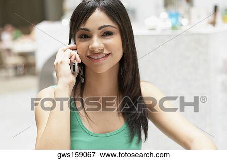 Close-up of a teenage girl talking on a mobile phone View Large Photo Image Stock Photo - Close-up of a teenage girl talking on a mobile phone. Fotosearch