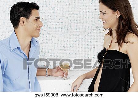 Close-up of a young couple looking at each other and smiling View Large Photo Image Stock Photo - Close-up of a young couple looking at each other and smiling. Fotosearch