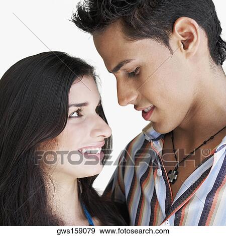 Stock Photo - Close-up of a young couple looking at each other. Fotosearch