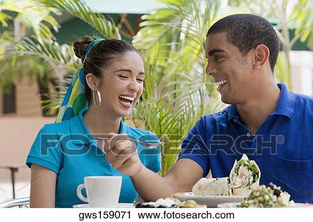 Close-up of a young man and a teenage girl sitting in a restaurant and smiling View Large Photo Image Stock Image - Close-up of a young man and a teenage girl sitting in a restaurant and smiling. Fotosearch
