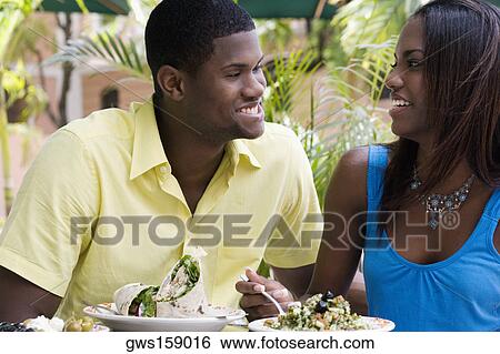 Stock Photograph - Close-up of a young man and a teenage girl sitting in a restaurant. Fotosearch