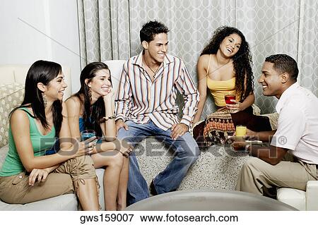 Stock Photo - Group of friends talking to each other and smiling. Fotosearch