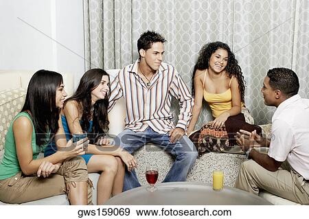Stock Photo - Group of friends talking to each other and smiling. Fotosearch