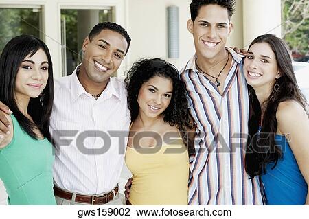 Portrait of a group of friends standing side by side and smiling View Large Photo Image Stock Image - Portrait of a group of friends standing side by side and smiling. Fotosearch