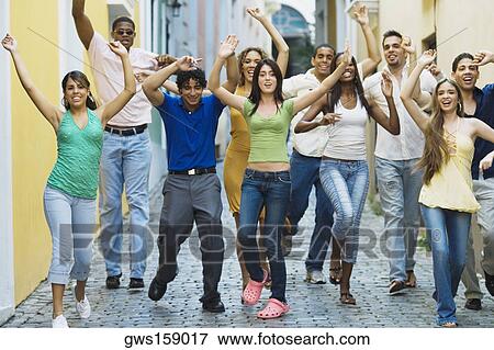 Stock Photo - Portrait of a group of friends walking on the street. Fotosearch