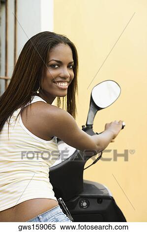 Portrait of a teenage girl on a moped View Large Photo Image Stock Photography - Portrait of a teenage girl on a moped. Fotosearch