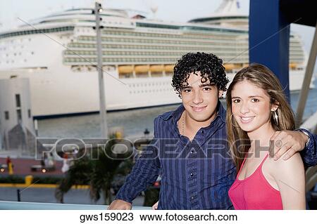 Portrait of a young man standing with a teenage girl View Large Photo Image Stock Image - Portrait of a young man standing with a teenage girl. Fotosearch