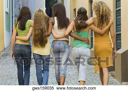 Rear view of five teenage girls walking with their arm around each other View Large Photo Image Stock Photography - Rear view of five teenage girls walking with their arm around each other. Fotosearch