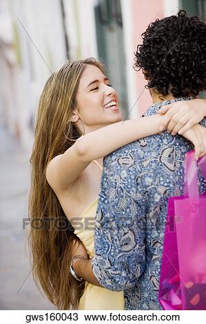 Close-up of a teenage girl embracing a young man View Large Photo Image Stock Image - Close-up of a teenage girl embracing a young man. Fotosearch