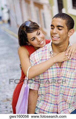 Close-up of a teenage girl embracing a young man from behind View Large Photo Image Stock Photograph - Close-up of a teenage girl embracing a young man from behind. Fotosearch