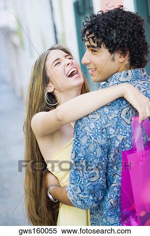 Close-up of a teenage girl embracing a young man and laughing View Large Photo Image Stock Photography - Close-up of a teenage girl embracing a young man and laughing. Fotosearch