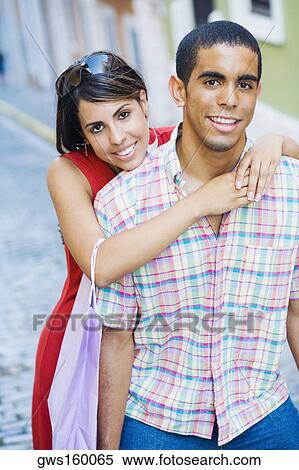 Portrait of a teenage girl embracing a young man from behind View Large Photo Image Stock Photography - Portrait of a teenage girl embracing a young man from behind. Fotosearch